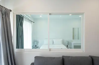 a large mirror in a living room with a couch at Phuket Villa 1 bedroom apartment in Patong in Patong Beach