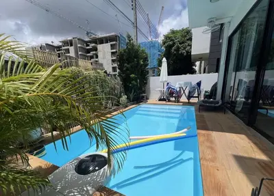 a blue swimming pool on top of a building at 4 bedroom Laguna Pool Villa in Laguna Phuket