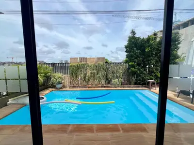 a swimming pool seen through a window at 4 bedroom Laguna Pool Villa in Laguna Phuket