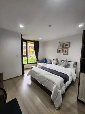 a bedroom with two beds and a large window at The Base Central Phuket-C54BS in Phuket Town
