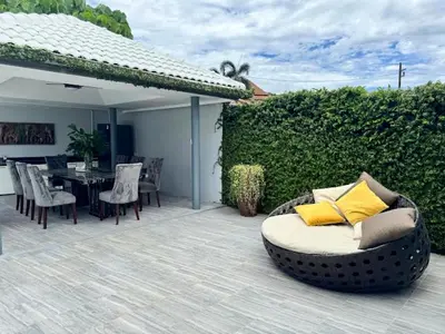 a wicker couch sitting on a patio with a table at Dolce Vita Villa Memory Bang-Tao Phuket in Ban Thalat Choeng Thale