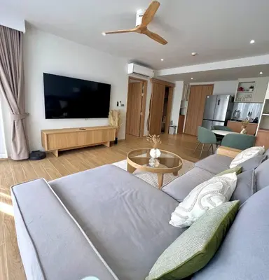 a living room with a couch and a flat screen tv at Laguna BeachSide 200m to beach BangTao in Bang Tao Beach