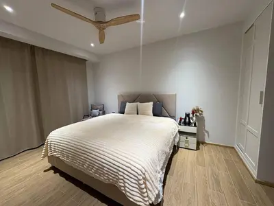 a bedroom with a bed and a ceiling fan at Laguna BeachSide 200m to beach BangTao in Bang Tao Beach