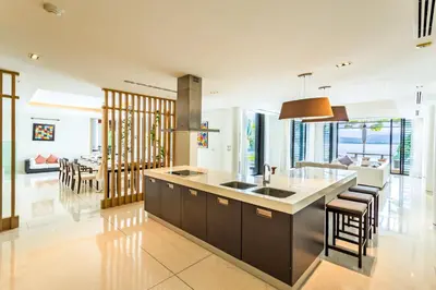 a kitchen with a sink and a counter top at Exclusive Oceanfront Living, 5BR Pool Villa Elegance in Ko Lek