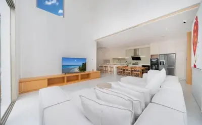 a living room with white furniture and a kitchen at Ola-Villa in Kamala Beach