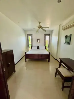 a bedroom with a bed and a ceiling fan at Oxygen Villa 3 beds in Rawai Beach