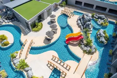 an aerial view of a resort pool with a water park at Private Pool View 1BR Apartment in Naiharn Residence near Beach, UTN D502 in Rawai Beach