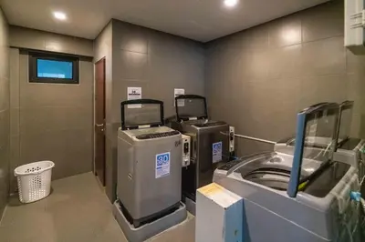 a bathroom with a washer and a washing machine at Private Pool View 1BR Apartment in Naiharn Residence near Beach, UTN D502 in Rawai Beach