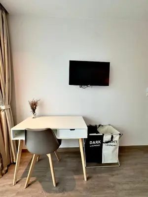 a desk with a chair next to a white wall at 2BR 4Beds Luxury Condo Pool & Fitness in Phuket Town