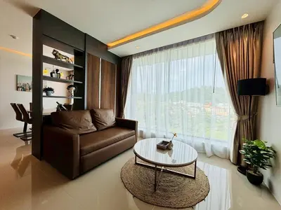 a living room with a couch and a glass table at 2BR 4Beds Luxury Condo Pool & Fitness in Phuket Town