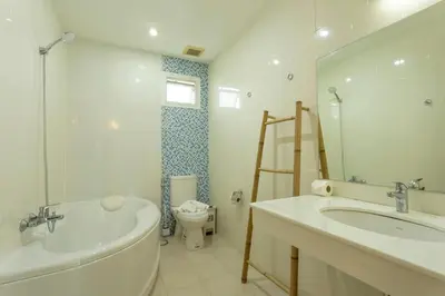 a bathroom with a tub and a sink and a toilet at V129 Walking To Award winning Naiharn Beach 4BR in Rawai Beach