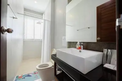 a bathroom with a white sink and a toilet at V68 Paradise Found 2BR Villa Bliss in rawai in Kata Beach