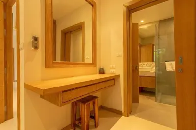 a bathroom with a sink and a mirror at V91 Where The Rich People Go Trichada Resort in Thalang