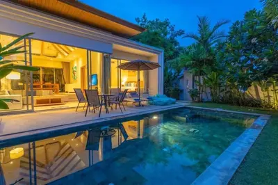 a villa with a swimming pool and a house at V91 Where The Rich People Go Trichada Resort in Thalang