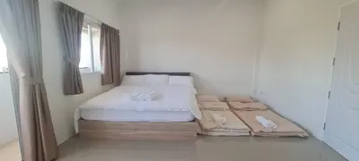 a bedroom with a bed with white sheets and a window at Cosy Home in Koh Kaew in Ban Bang Khu