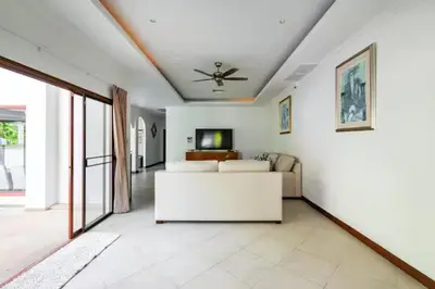 a living room with a couch and a ceiling fan at Surin villa by Pattara in Surin Beach
