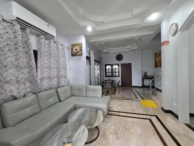 a living room with a couch and a table at Diamond Home in Phuket in Ban Rangeng