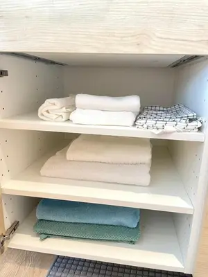 a shelf with towels and towels on it at Studio surin-bangtao beach in Surin Beach