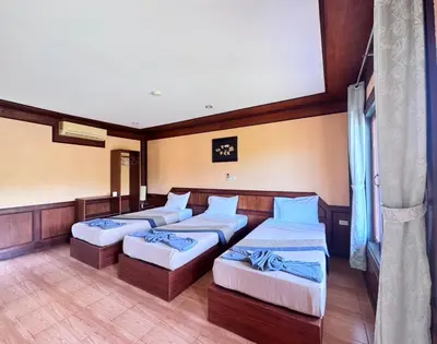a room with four beds in a room at Phi Phi Treetop in Phi Phi Don