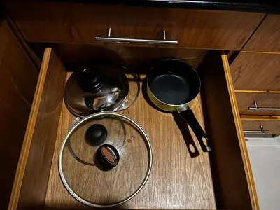 a wooden drawer with some utensils and a strainer at Thebirdhouse Patong Phuket 202 in Patong Beach