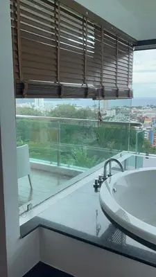 a bathroom with a large window with a tub and a sink at Thebirdhouse Patong Phuket303 in Patong Beach