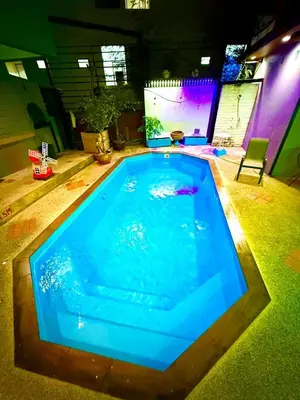 a large blue swimming pool in a room at Hill Side Patong Hotel in Patong Beach