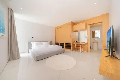 a bedroom with a bed and a flat screen tv at Exclusive 4BR Pool Designer Villa in Lux Pride 2 V6 Residence, Near Laguna in Bang Tao Beach