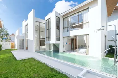 an exterior view of a white house with a swimming pool at New Build Masterpiece with Private Pool - 4BR Villa in Lux Pride 2 V7 Residence in Bang Tao Beach
