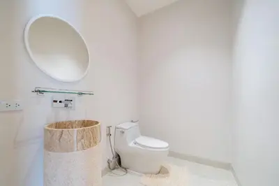 a bathroom with a toilet and a mirror at New Elegance & Tropical Luxury - 4BR Pool Villa in Lux Pride 2 V8 Residence, near Laguna in Bang Tao Beach