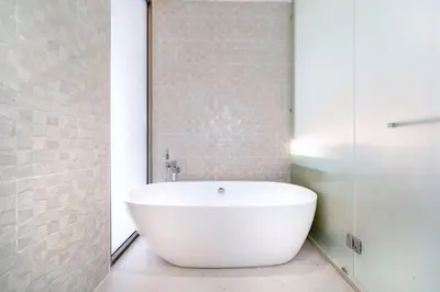 a white bath tub in a bathroom with a shower at New Elegance & Tropical Luxury - 4BR Pool Villa in Lux Pride 2 V8 Residence, near Laguna in Bang Tao Beach