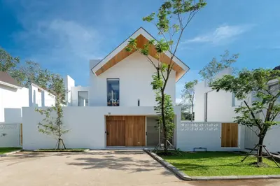 a white house with a wooden roof at Your Private Piece of Paradise! 4BR Pool Villa in the New Lux Pride 2 V9 Residence in Bang Tao Beach