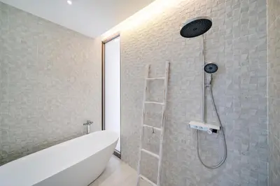 a bathroom with a shower with a white bath tub at Modern Elegance & Tropical Vibe - 4BR Pool Villa in New Build Residence Lux Pride 2 V10 in Bang Tao Beach