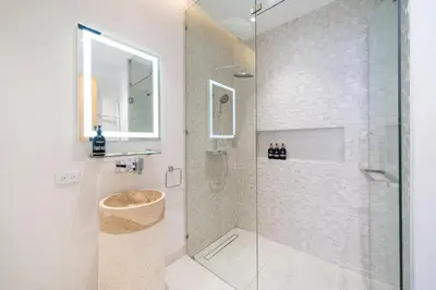 a bathroom with a shower with a glass door at Exclusive Living in Designer 4BR Pool Villa in Lux Pride 2 V11 Residence, Near Laguna in Bang Tao Beach