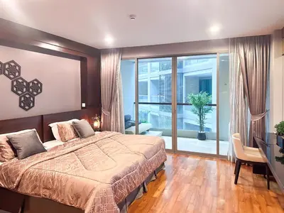 a bedroom with a large bed and a large window at Cozy studio near Bangtao Beach in Bang Tao Beach