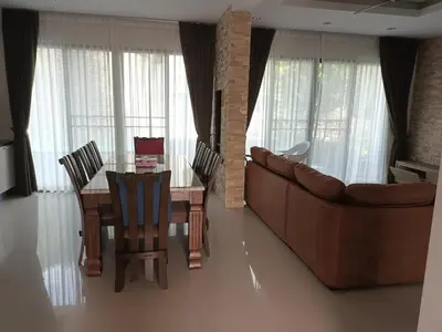 a living room with a table and a couch at Luxury spacious 3 bdr apartment Pandora residence in Nai Harn Beach