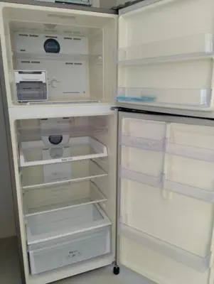 a white refrigerator with its door open in a kitchen at Luxury spacious 3 bdr apartment Pandora residence in Nai Harn Beach