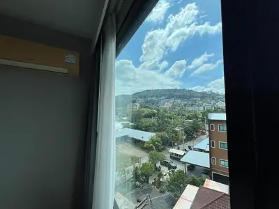a window in a room with a view of a city at Condo Surin-Bangtao Beach in Surin Beach