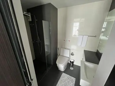 a bathroom with a toilet and a sink and a shower at Condo Surin-Bangtao Beach in Surin Beach