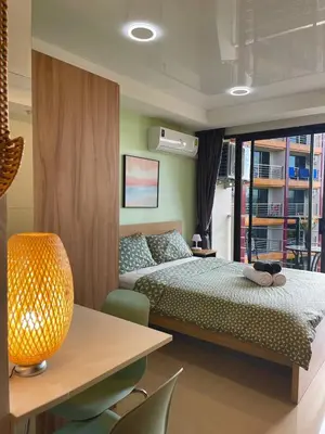 a bedroom with a bed and a table and chairs at Skyline Retreat in Ban Mai Salae