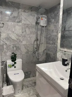 a bathroom with a shower and a toilet and a sink at Skyline Retreat in Ban Mai Salae
