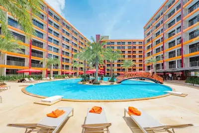 a large swimming pool with chairs and a building at Skyline Retreat in Ban Mai Salae