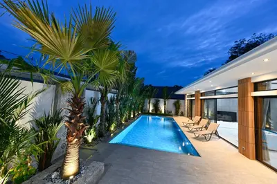 a swimming pool in the backyard of a house at Diamond 1 Villa by G Estate Phuket in Ban Saiyuan (1)