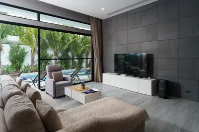 a living room with a couch and a flat screen tv at Diamond 1 Villa by G Estate Phuket in Ban Saiyuan (1)