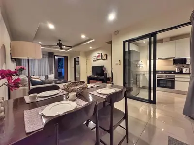 a kitchen and living room with a table and chairs at Laguna Park 3BR Townhouse BangTao in Laguna Phuket