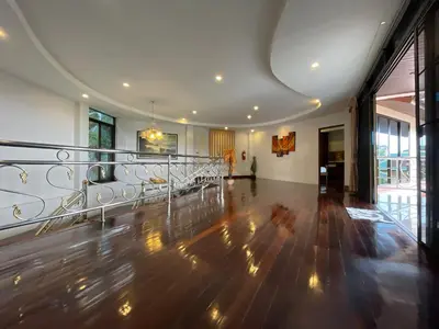 a large room with a wooden floor and a balcony at Вилла в сердце Пхукета in Surin Beach