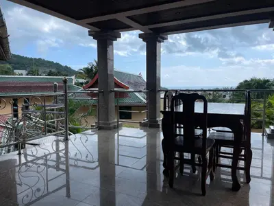 a table and two chairs on a balcony with a view at Вилла в сердце Пхукета in Surin Beach