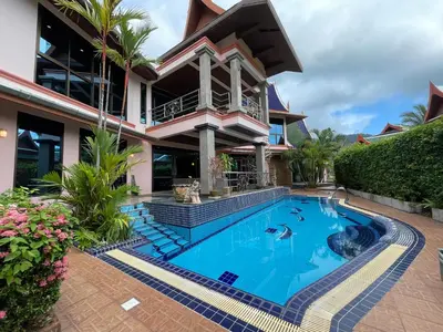 a swimming pool in front of a house at Вилла в сердце Пхукета in Surin Beach