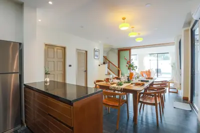 a kitchen and dining room with a table and chairs at Summer Villa Patong in Patong Beach