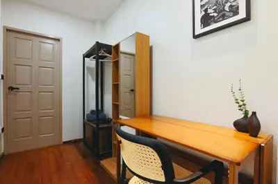 a room with a wooden table and a mirror at Summer Villa Patong in Patong Beach
