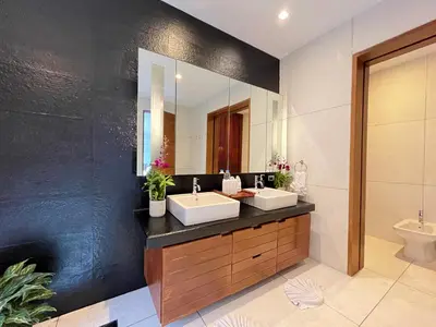 a bathroom with two sinks and a mirror at Laemsingh Villa 1 - Luxury Villa 5 Bedrooms in Surin Beach